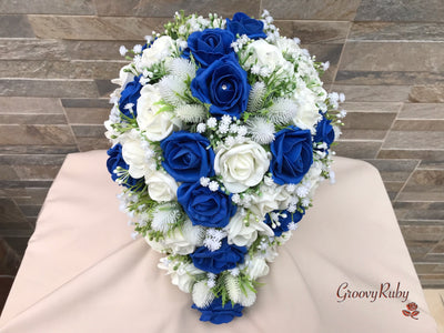 Royal Blue Foam Roses With Off White Thistle & Gypsophila